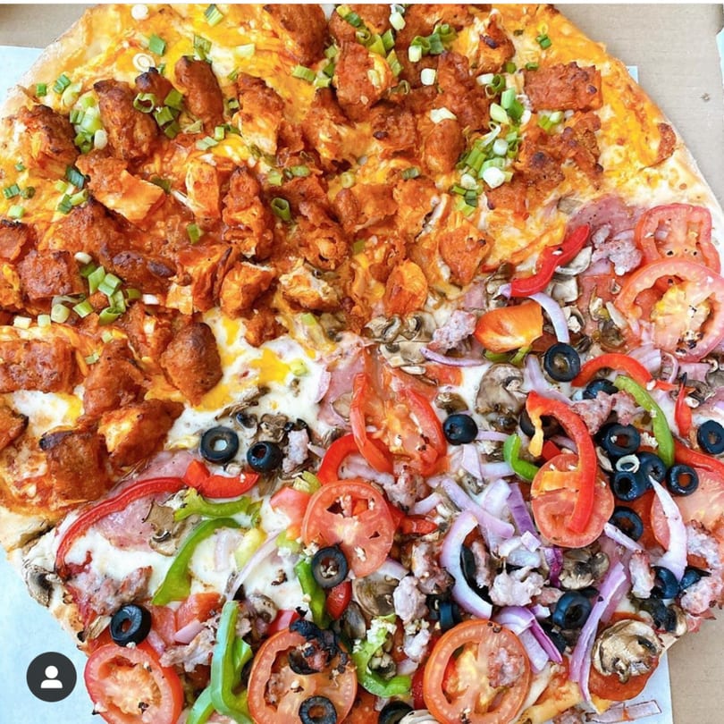A Big Daddy's Pizza & Wings pizza with two distinct halves: buffalo chicken and supreme.